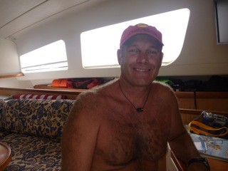 Rodney sporting his new necklace that RJ made for him.  Notice the new cushion covers on the boat!