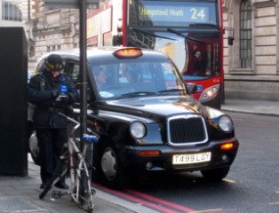 Not sure if the cyclist will care about the ticket - notice the black taxi in the background - all London cabs are like that