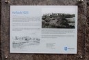 Sign has photo of Keflavik harbor in 1920. Volcanic rock has been added after this photo.
