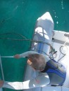 Paul probing the fishing line with the boat hook from the dinghy