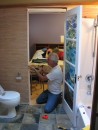 Jim installs Carols doors at Thetis. The doors were inset with a fused glass mural created by Carol