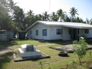 Many houses on Aitutaki have graves in the yard.