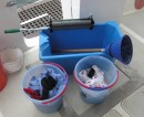 The laundry system stage 1. The conical gadget with the handle is the washing machine and the wringer is out of the ark! Both pieces of gear are manufactured today in the USA for tha Amish community who eschew electricity.