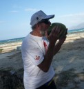 Enjoying the milk of a huge green coconut. After drinking, the climber who picked the fruit for us opened the nut and fashioned coconut shell spoons for us to scrape out and eat the soft flesh. Didn
