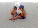 Two children playing in the sand of the harbour.

Juste a cote, pres du marche et du port, 2 petits enfants polynesiens jouent dans le sable.