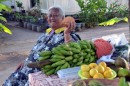 Mama Tahutu selling fruit in front of her house