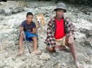 A Tongan villager with his son on the shore of Pangaimotu Island