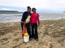 Tonga woman and daughter collecting edible sealife at low tide on Pangiamotu