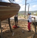 Alice kabitzin with one of the boat builders as he preps the transum for sanding.