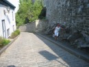 Alice holding up the fortress wall.  Winding cobble-stone street from the upper city to the lower.