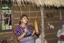 Local museum guide demonstrating some of the traditional musical instruments still used today during festivals and celebrations