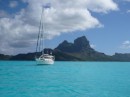 Enchantment anchored off a motu with Bora Bora behind us