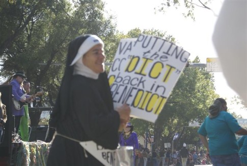 She followed the "Pope" and handed out joke condoms and communion wafers