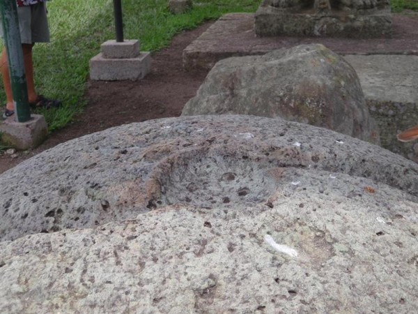 If you displeased the king they rested your head into the scooped out depression in the top of this very large round stone,  then chopped it off.  The curving troughs exiting the depression were designed to drain off the blood.