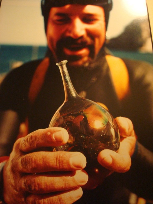Happy scuba diver with glass treasure