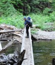Alison is glad a good log bridge spans the Deception Creek near the end of the trail.