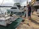Game fishing charter unloading a sailfish on the jetty in front of the café.