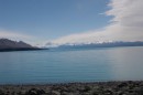 Lake Putaki, South Island, NZ.  One of several glacier fed lakes. These lakes are ice cold, light blue but cloudy.  The glacial waters that feed them contain large amts of particulates which accounts for the color.  These particulates also gum up outboard engines.  There are no small boats on these lakes. 