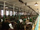A small mill room with only about 20% of the machines normally present. Only about 10 of the machines were working, and the sound was deafening
