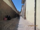 Side street in the historical center of Cusco, with the original Inca stones present as the base of the buildings.  You can see how the Inca walls slanted inward.