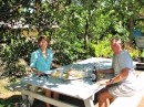 Gail & Tony having lunch on the picnic table by the grocery store