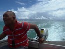 Driving Ros and the 3 officials through the reef pass to Pukapuka; while David stays aboard Barefoot, too deep to anchor.