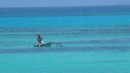 A local, fishing from a canoe in the lagoon