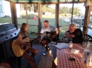 Back at Deltaville Marina after a walk through town Jim right) joins a fellow sailor and his daughter in a guitar jam session.