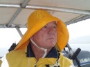 "Be Prepared" is a motto the captain favors, and so a little rain gives him no trouble in his foul weather gear. 