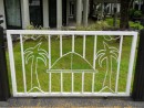 This fence segment depicts a fale ("house") and palm trees.