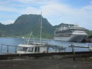 This large cruise ship is dwarfed by Rainmaker, the mountain in the background.