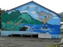 A mural on the side of a building on the backside of town (awy from the water) 