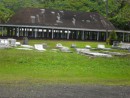 A faleoo, or open-air covered village meeting place, serves as the backdrop for this cemetery. (For more cemetery photos, see sub album "Cemeteries of the South Pacific" in the "Hiva Oa & Fatu Hiva" album.)  