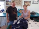 Proprietess Cindy takes a look at our stack pack sail cover while Jim explains what needs to be done. (Custom Marine Canvas, St. Augustine FL)