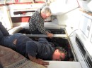 It appears that our boats are not the only ones that have ever needed to be worked on. Here, Charlie (front) and Jim check things out in the engine compartments. 