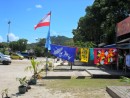 Cheerful pareos wave in the breeze beside a French Polynesian flag at one local shop. 