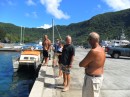 From left: Eric (Sidetrack), Joe (Panacea), Natasha (Puppy), Jim (Cactus Wren), and Mac (Honu) stand ready to assist as they await the arrival of Puppy, which Anatoli is moving from a mooring in the harbor to the dock at Malaloa Marina.