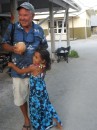Telecom Celebration: A Palmerston youngster gives Jim a very warm welcome to the island.