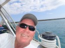 Happy to be cleared in to this tiny port, Capt. Jim hams it up for the camera. (Isla Beata, Dominican Republic.)