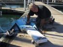 Maintenance is constant on a boat. Here Jim prepares the Autohelm rudder for a fresh coat of anti-fouling paint.