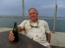 Jim enjoys a cold one on the Yacht Club deck while cooling winds blow.