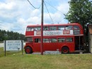 This bright double-decker bus, parked by the highway, heralds the English establishment.