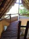The upstairs bedroom suite includes this wooden bridge to a seating area with a great view.