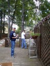 Once the trellis has been erected, Best Man Brian (foreground) and John go to work stringing lights and decorating the deck, which will serve as the dance platform at the reception.