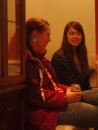Meanwhile, Heather (left) and Erica sit across the room holding a more subdued conversation.
