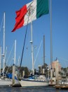 Cactus Wren in her slip at Baja Naval with the Mexican flag flying proudly overhead in the adjacent park.