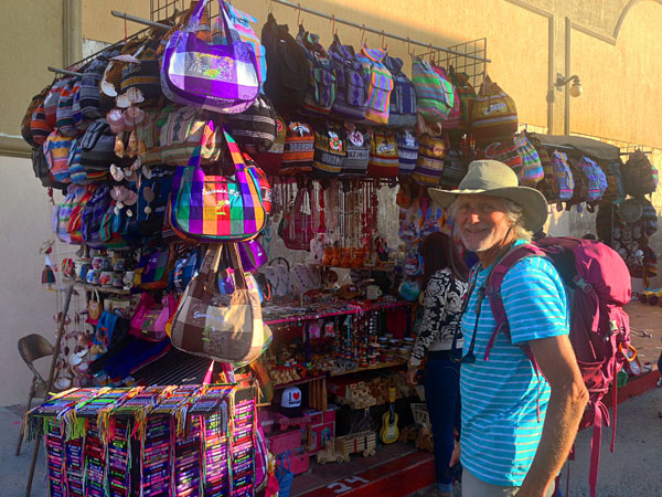 Gringo-Kirk checking out the wares at one of the trinket stands and wondering if he should trade-in our Osprey backpack for a Mexican backpack? Nah...