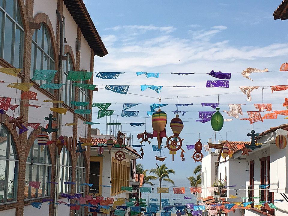 Mexican streets are often decorated with "Papel picado", cut paper banners including themes of birds, floral designs, and skeletons. They are used to decorate for any Mexican holiday or celebration from Easter to Dia de los Muertos (and Mexico has a LOT of holidays...It seems like they have something to celebrate every couple of weeks!) This particular street in downtown PV also has nautical forms hanging from the papel picado, making it even more festive.