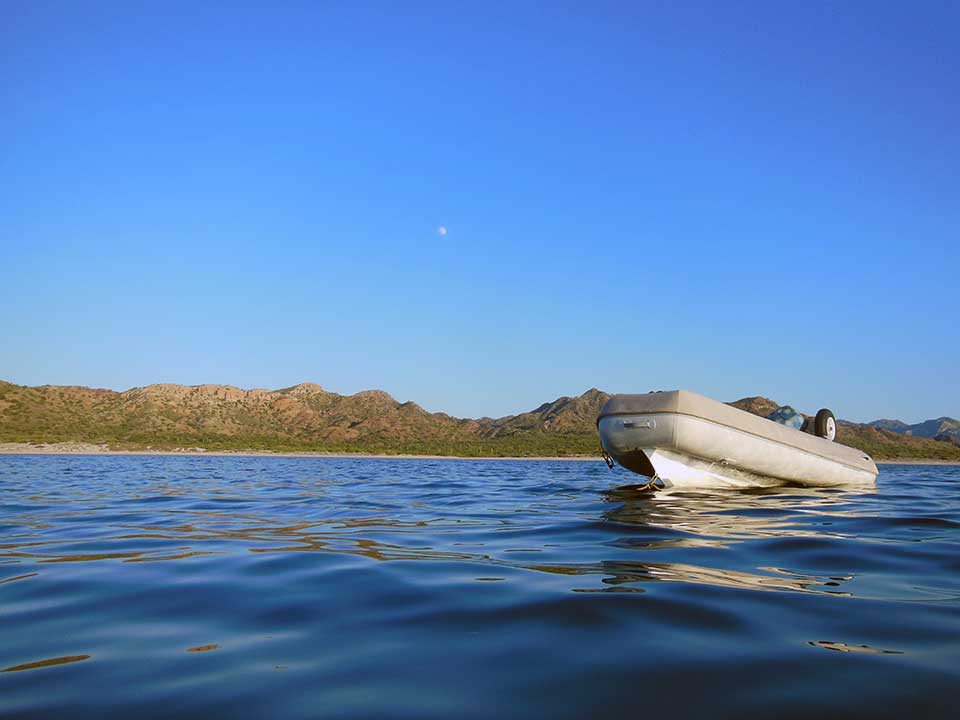 Our "other boat" (our car!), our awesome RIB dinghy, "Aventuras" bobbing in the water in Bahia Santo Domingo with the full-moon over-head. We LOVE our dinghy, the best one we