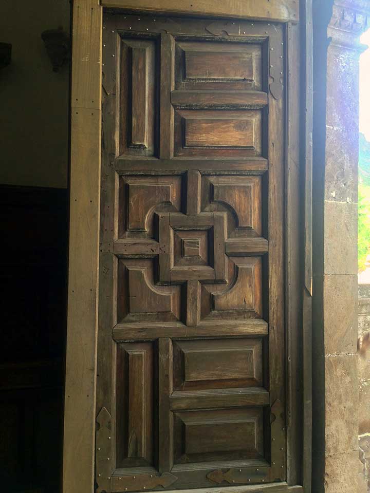 Intricate wood carvings on the 300+ year old original massive wood doors.